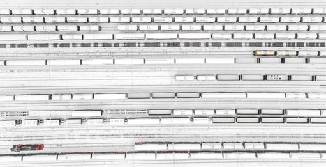 Aerial view of freight train yard covered in snow