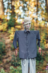 scarecrow from old clothes in the garden.