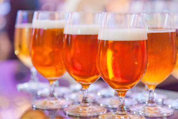 Selective Focused Glasses of Draught Beer or Craft Beer, Refreshment, Liquor, Alcoholic Drink, Beverage. Celebration Party Background. Beer brewed from cereal grain by brewer, Brewing Industry concept