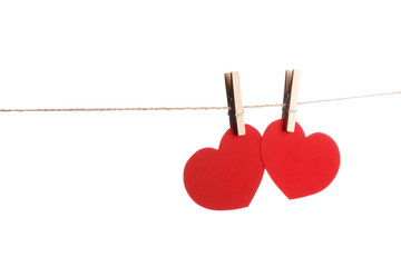 Clothes pegs and two red paper hearts