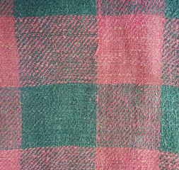 Old faded decrepit red black checked fabric texture