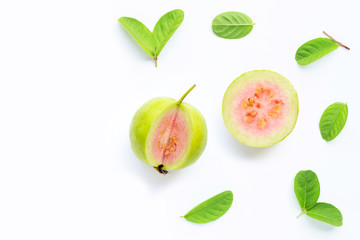 Pink guava with leaves on white background.