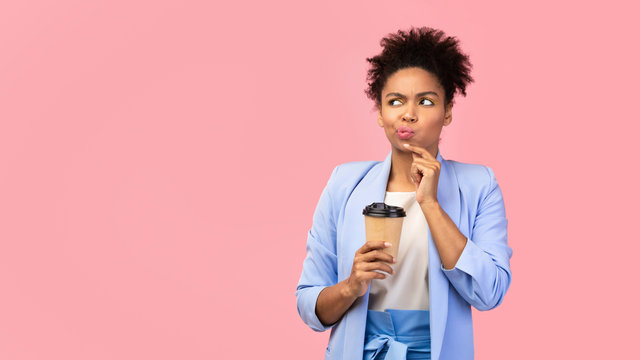 Pensive Afro Woman Holding Coffee Mug At Studio