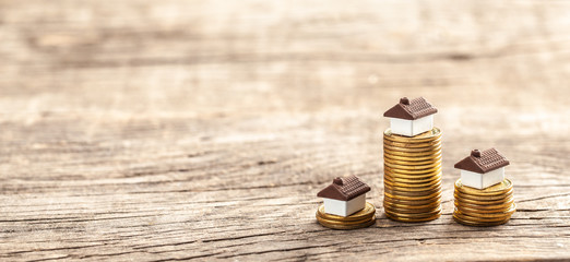 House and a stack of coins. The market price of the house. Real estate market growth.