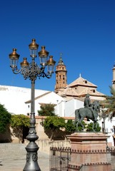 Fototapeta na wymiar Plaza Guerrero Munoz with the San Sebastian church tower and statue of Fernando I, Antequera, Spain.
