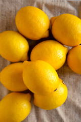 Ripe Yellow Organic Lemons on cloth, view from above. Flat lay, overhead, top view. Close-up.
