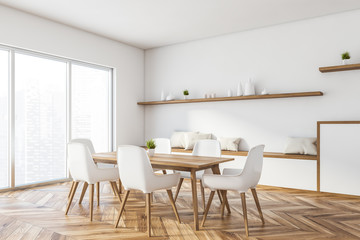 White panoramic dining room corner with cabinet