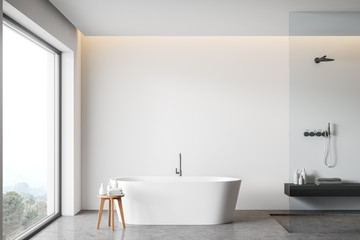 White bathroom interior with tub and shower