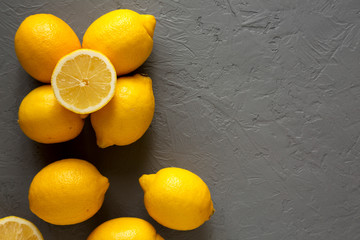 Fresh Ripe Yellow Organic Lemons on gray background, top view. Flat lay, overhead, from above. Copy...