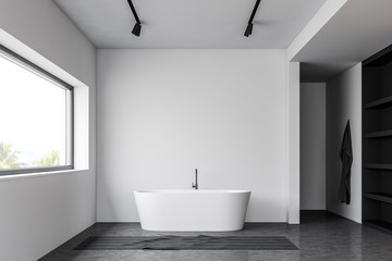 Fototapeta na wymiar Loft white bathroom with tub and shelves