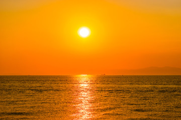 Fototapeta na wymiar Bright orange sunset over the sea.