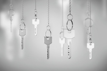 Silver keys on chains, real estate concept