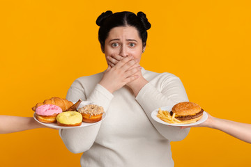 Plus Size Girl Covering Mouth, Rejecting To Eat Offered Junk Food