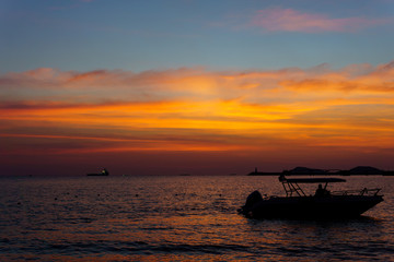 Fototapeta na wymiar Silhouette Sailboat In Sea Against Sky During Sunset