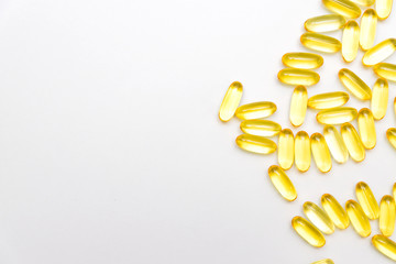 Pile of capsules Omega 3 on white background with copy space for your text