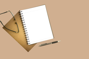 notebook and pen on brown background