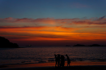 Silhouette People Standing At Beach During Sunset