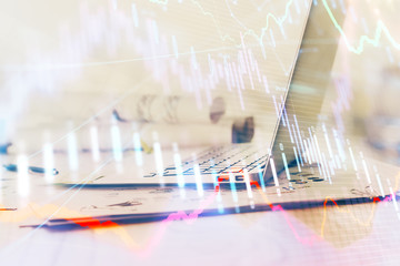 Forex graph hologram on table with computer background. Multi exposure. Concept of financial markets.