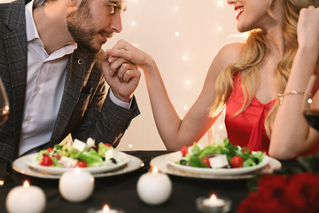 Gallant Man Kissing Hand Of Girlfriend On Romantic Dinner In Restaurant