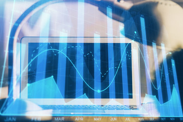 Stock market chart hologram drawn on personal computer background. Double exposure. Concept of investment.