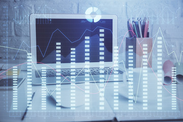 Financial chart drawing and table with computer on background. Multi exposure. Concept of...