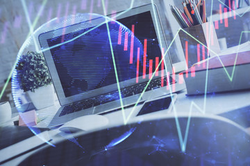 Financial market graph hologram and personal computer on background. Double exposure. Concept of forex.