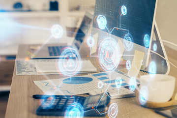 Double exposure of desktop computer and technology theme hologram. Concept of software development.
