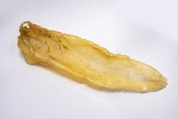Traditional health nourishing food Maw fish gum, a big catfish male gum on white background