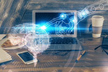 Multi exposure of work table with computer and brain hologram. Brainstorm concept.