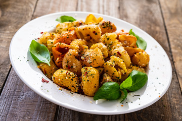 Pasta with pesto sauce on wooden table