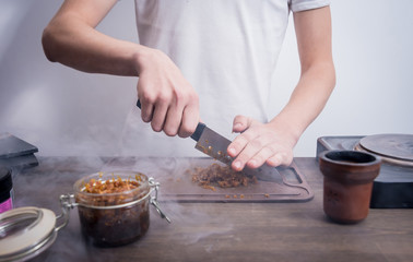 Cooking hookah in the bar. Cutting tobacco into a bowl. Restaurant