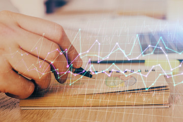 Multi exposure closeup hands with stock market forex graph.