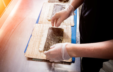 Process of making sushi and rolls at restaurant kitchen. 