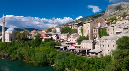Mostar / Bosnia and Herzegovina April 2019: Koski Mehmed Pasha Mosque in the center of shore of Neretva river in Mostar city, historic and touristic place in Balkan peninsula, Southeastern Europe