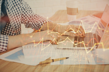 Multi exposure of stock market chart with man working on computer on background. Concept of financial analysis.