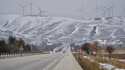 Fotobehang wind farms installed in the mountains, in winter © Vahit Telli
