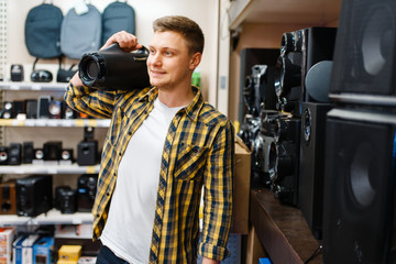 Man choosing music system in electronics store