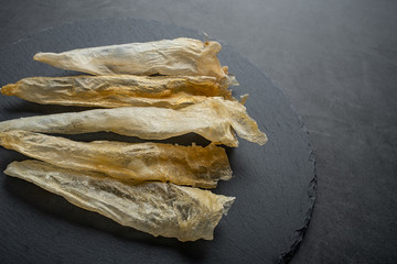 Traditional health nourishing food Maw, catfish glue on black slate tray