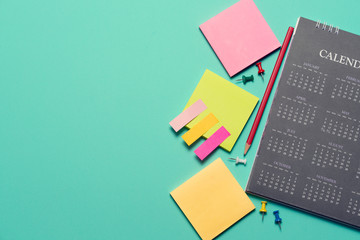 close up of calendar on the green table background, planning for business meeting or travel planning concept