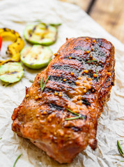grilled meat ribs with vegetables on wooden table