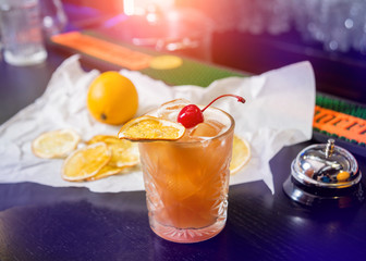 Non alcoholic cocktail with lemon and oranges at wooden bar counter. Restaurant.