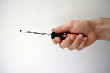 Male's hand holding screwdriver isolated on white background - obrazy, fototapety, plakaty