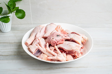 A dish of diced chicken on a kitchen tile countertop