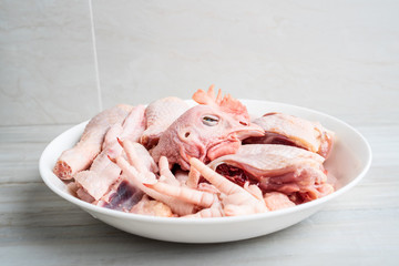 A dish of diced chicken on a kitchen tile countertop