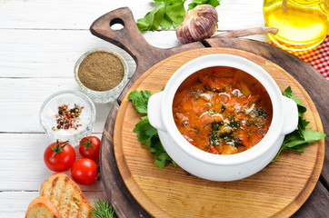 Baked meat with potatoes and vegetables in a bowl. Ukrainian traditional cuisine. Top view. Free space for your text.