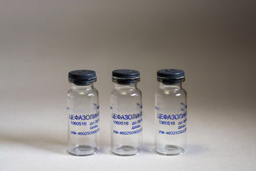 Three empty glass vials.