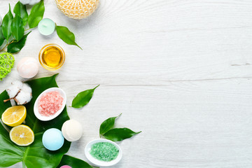 Sea salt bath bombs and spa treatments on a white table. Top view. Free space for your text.