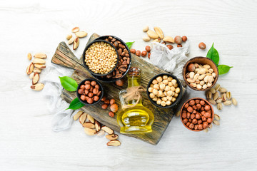 Cold pressed nut oil. Assortment of nuts. free space for your text. Top view.