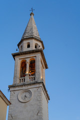Fototapeta na wymiar Old clock tower on a background of blue sky
