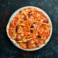 Pizza. Traditional pizza with sausages and french fries. Top view. Free space for your text.